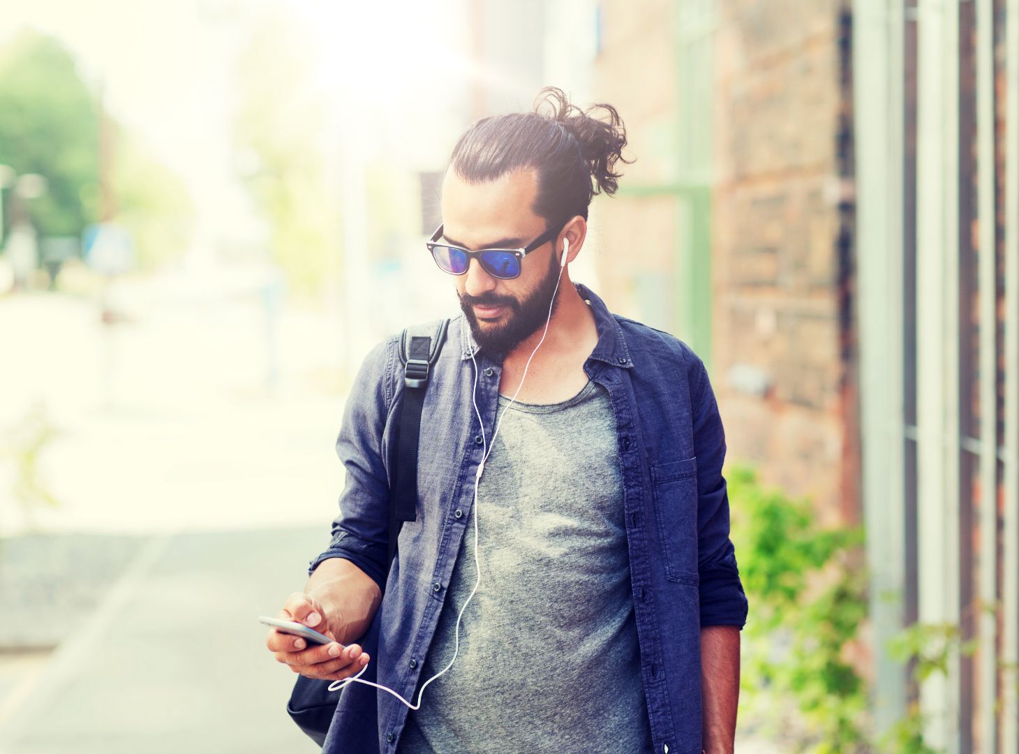 Image of man walking down road listening to a podcast