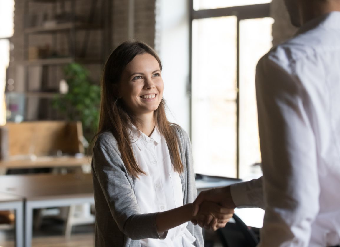 Business owner and accountant shaking hands during a meeting